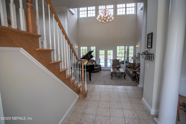 tiled foyer with french doors, carpet floors, and plenty of natural light