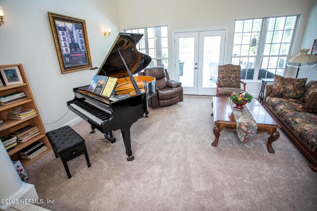 sitting room with french doors, carpet, and plenty of natural light