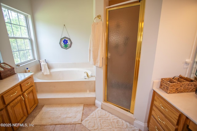bathroom featuring a stall shower, a bath, and vanity