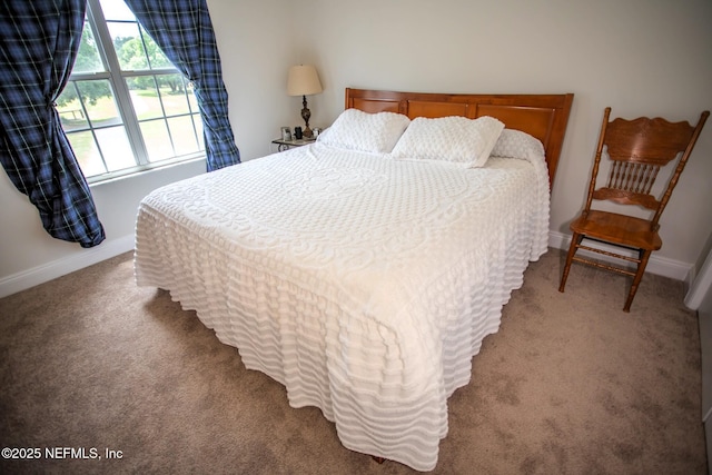 bedroom featuring baseboards and carpet floors