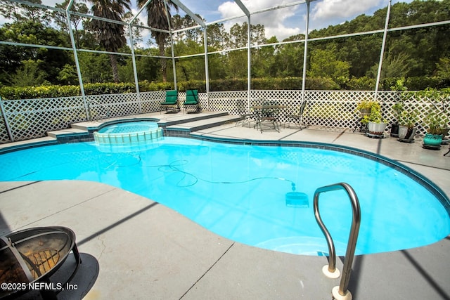 view of swimming pool with a patio, glass enclosure, and a pool with connected hot tub