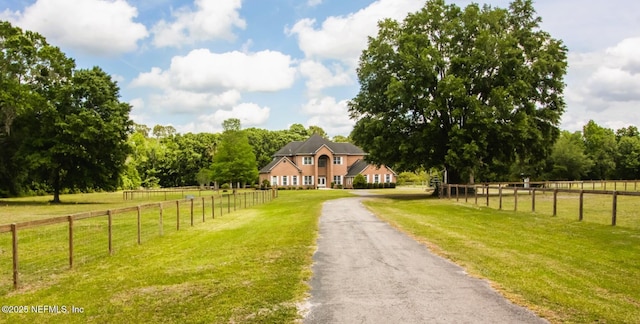 view of road featuring a rural view and aphalt driveway