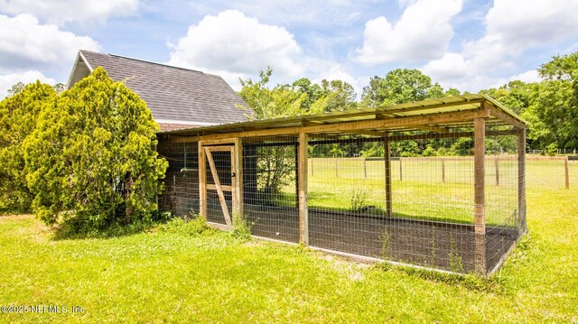 view of poultry coop featuring a lawn