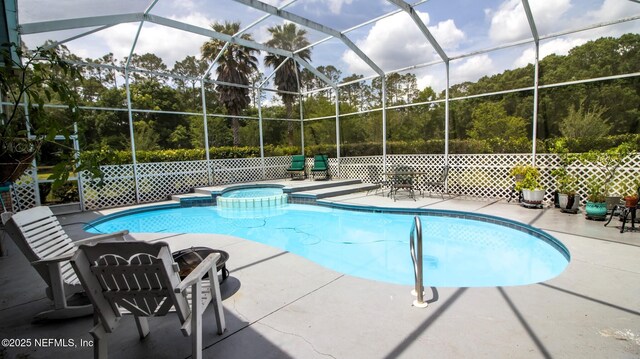 view of pool featuring a lanai, a patio, and a pool with connected hot tub