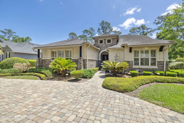 prairie-style home with stucco siding and stone siding