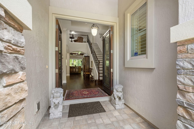 property entrance featuring stone siding