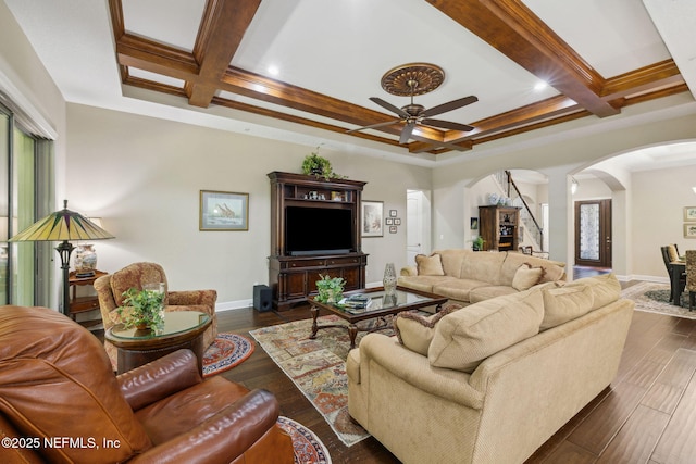 living area with arched walkways, ceiling fan, baseboards, and coffered ceiling