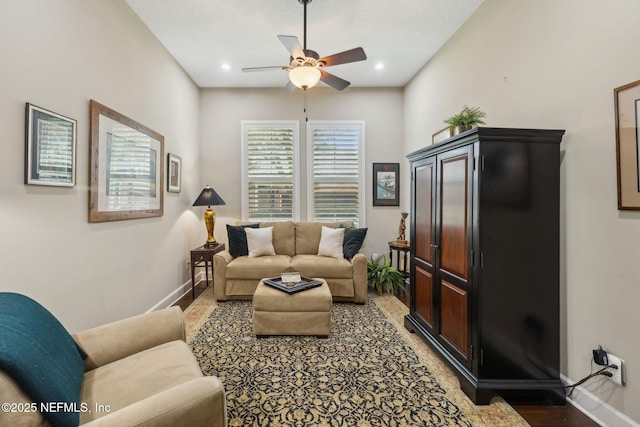 living room featuring baseboards, ceiling fan, and recessed lighting