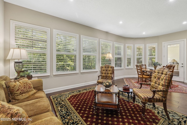 sunroom / solarium featuring plenty of natural light, recessed lighting, baseboards, and wood finished floors