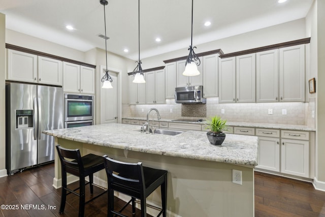 kitchen with backsplash, stainless steel appliances, recessed lighting, and a sink