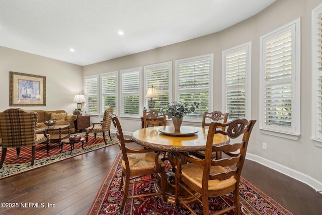 dining room featuring baseboards, recessed lighting, and dark wood finished floors