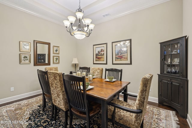 dining room featuring baseboards, a notable chandelier, ornamental molding, and dark wood finished floors