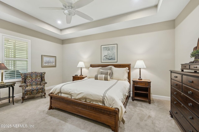 bedroom featuring baseboards, ceiling fan, light colored carpet, recessed lighting, and a raised ceiling