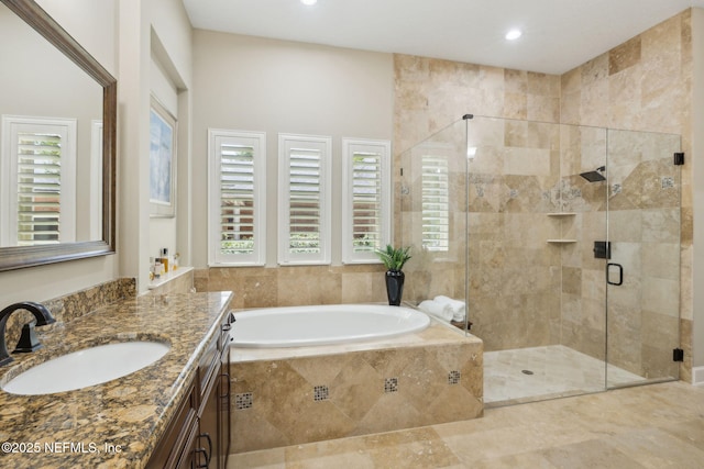 bathroom featuring vanity, recessed lighting, a garden tub, and a stall shower