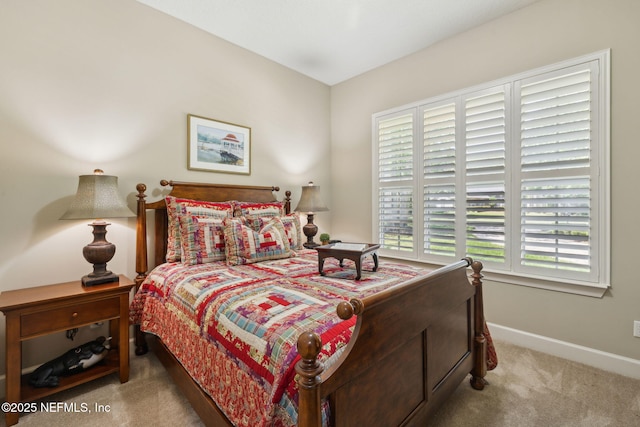 bedroom with baseboards and carpet flooring