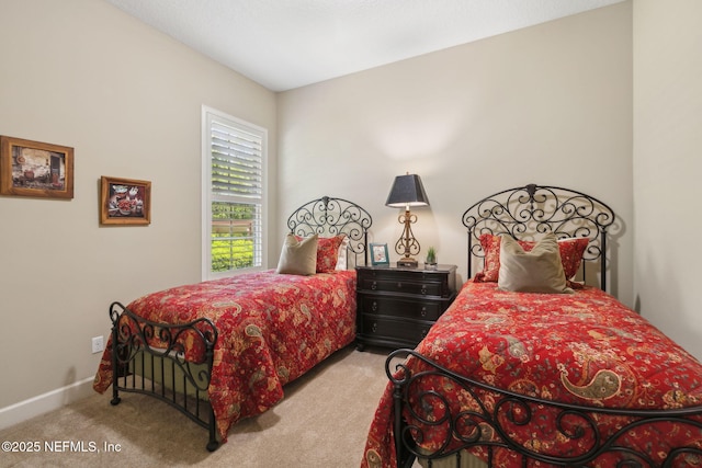 bedroom with baseboards and carpet