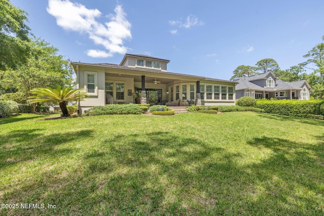 back of house with a yard and a ceiling fan