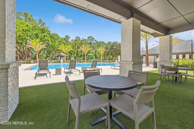 4583 Swilcan Bridge Ln N, Jacksonville, FL 32224 - view of patio / terrace featuring outdoor dining area, a community pool, and fence