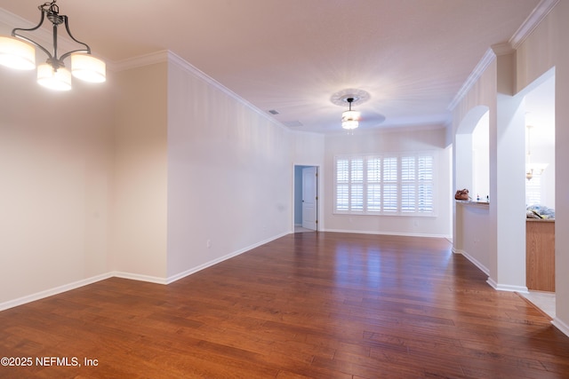 spare room with ornamental molding, dark wood-style flooring, and a notable chandelier