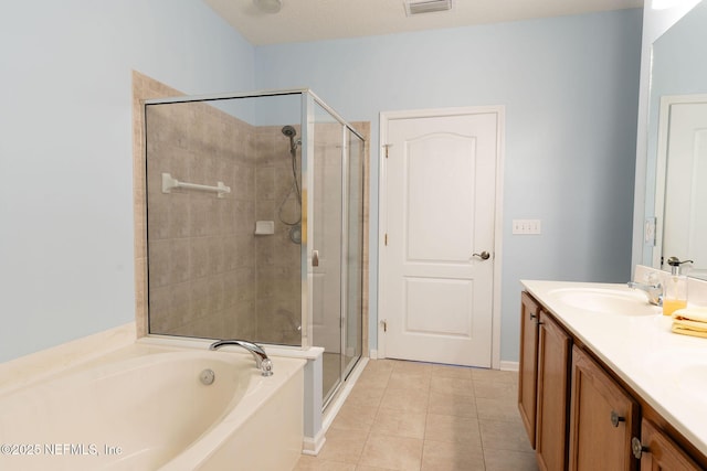 bathroom with double vanity, a garden tub, a stall shower, a sink, and tile patterned floors