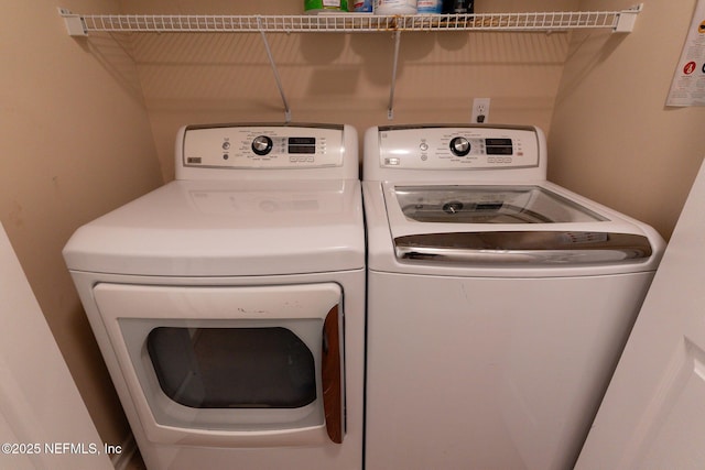 washroom featuring separate washer and dryer and laundry area