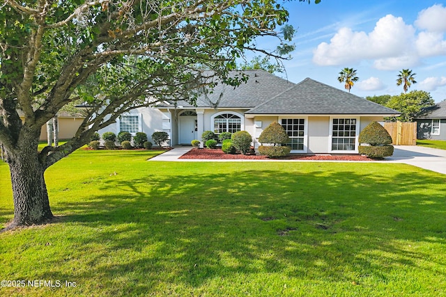 245 Village Green Ave, Fruit Cove, FL 32259 - ranch-style home featuring stucco siding, a front lawn, roof with shingles, and fence