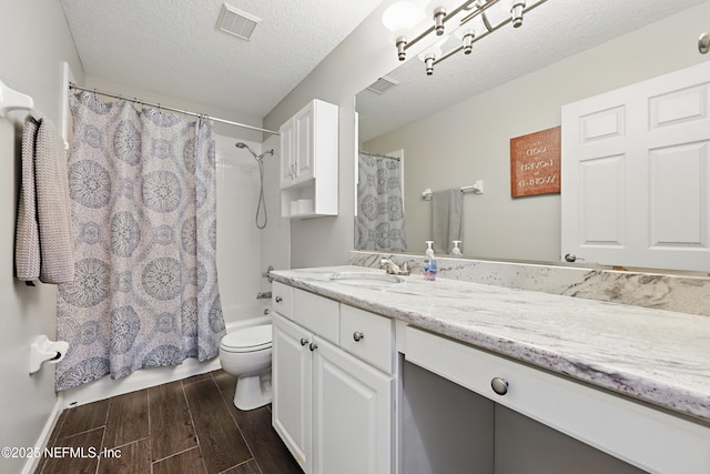 245 Village Green Ave, Fruit Cove, FL 32259 - full bathroom featuring wood finished floors, visible vents, toilet, vanity, and a textured ceiling