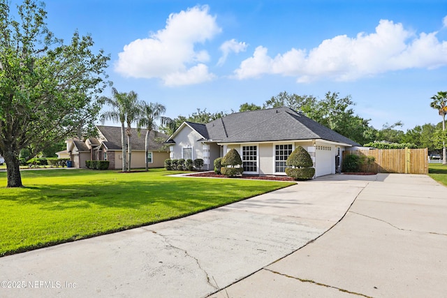 245 Village Green Ave, Fruit Cove, FL 32259 - view of front of home featuring a front lawn, driveway, fence, an attached garage, and stucco siding