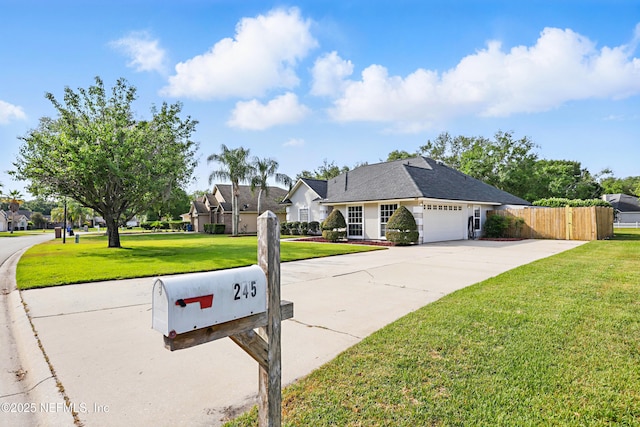 245 Village Green Ave, Fruit Cove, FL 32259 - view of front of property with fence, an attached garage, a front lawn, and concrete driveway