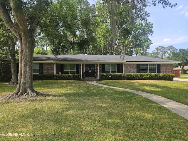 ranch-style home with a front lawn and brick siding