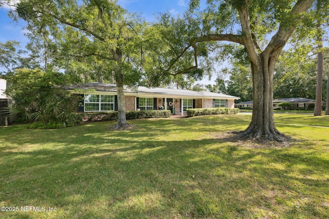 single story home featuring a front lawn and brick siding