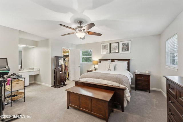 bedroom featuring baseboards, ceiling fan, and light carpet