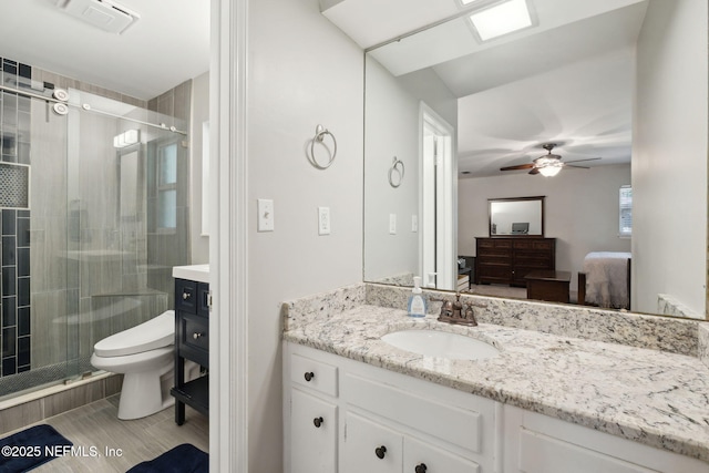 ensuite bathroom featuring visible vents, connected bathroom, toilet, and vanity