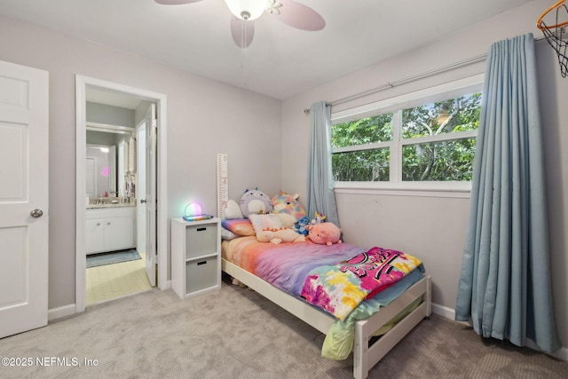 carpeted bedroom with baseboards, ceiling fan, and ensuite bath