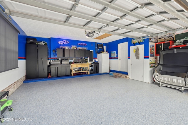 garage with freestanding refrigerator and a garage door opener