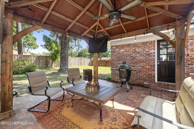 view of patio / terrace with a gazebo, a ceiling fan, a fenced backyard, and grilling area