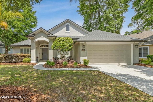 view of front facade featuring driveway, roof with shingles, a front yard, stucco siding, and a garage