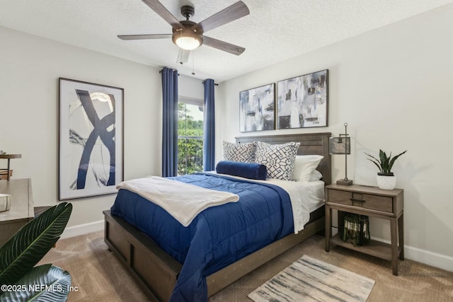 carpeted bedroom with baseboards, a ceiling fan, and a textured ceiling