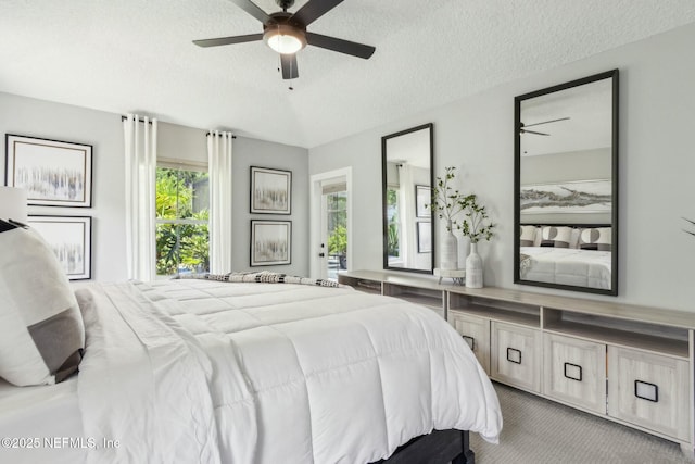 carpeted bedroom featuring a textured ceiling and a ceiling fan