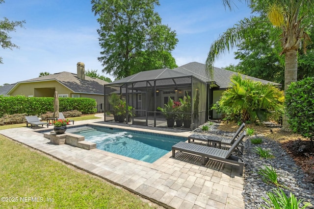 pool featuring a lanai, a hot tub, and a patio area
