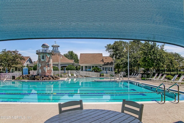 pool featuring a patio and fence