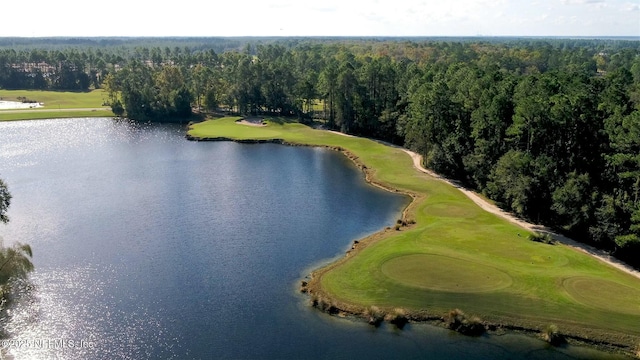bird's eye view with a wooded view, golf course view, and a water view
