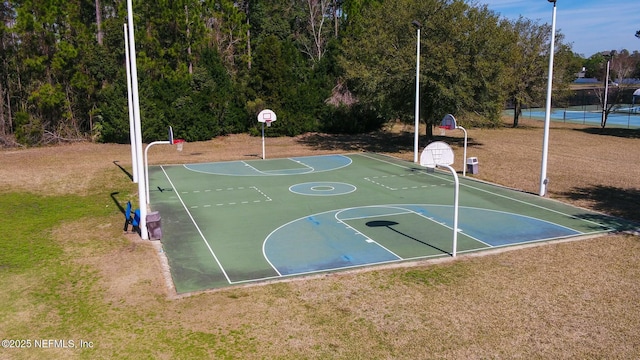 view of sport court featuring community basketball court and a yard