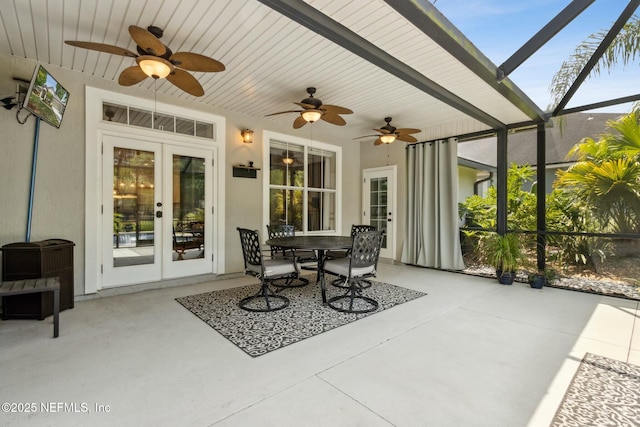 sunroom / solarium featuring ceiling fan and french doors