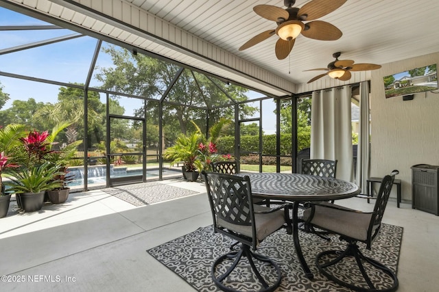 sunroom / solarium featuring ceiling fan and outdoor dining space