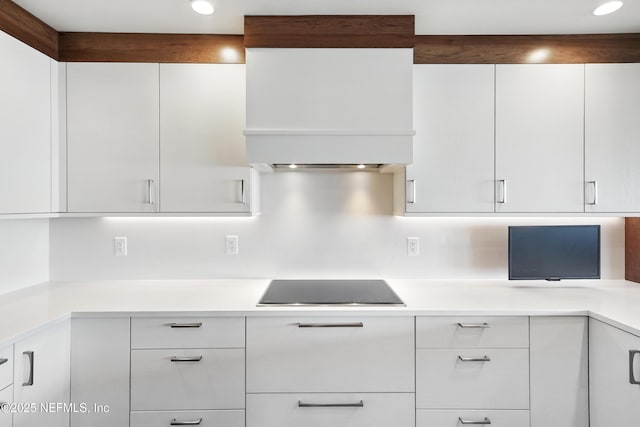 kitchen with modern cabinets, custom exhaust hood, white cabinetry, and recessed lighting