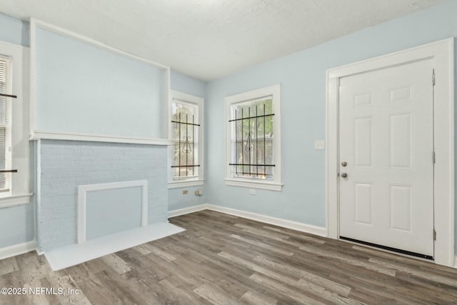 entryway with wood finished floors and baseboards