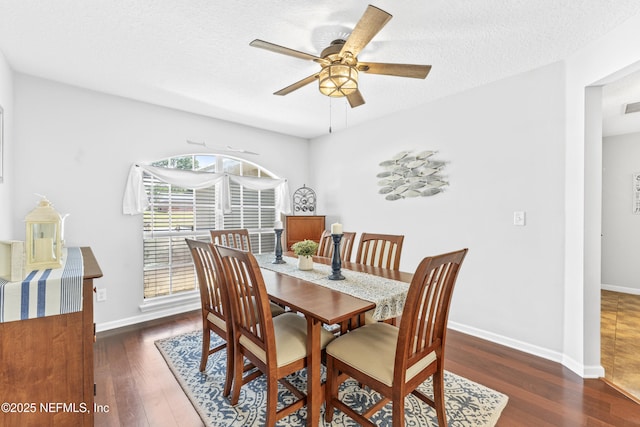 dining space with baseboards, ceiling fan, wood finished floors, and visible vents