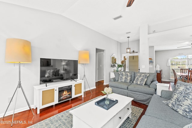 living area with baseboards, a ceiling fan, dark wood-style flooring, and visible vents