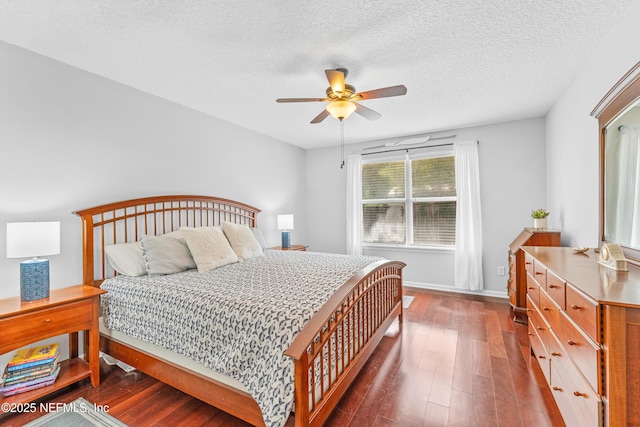 bedroom with a ceiling fan, a textured ceiling, dark wood-style floors, and baseboards